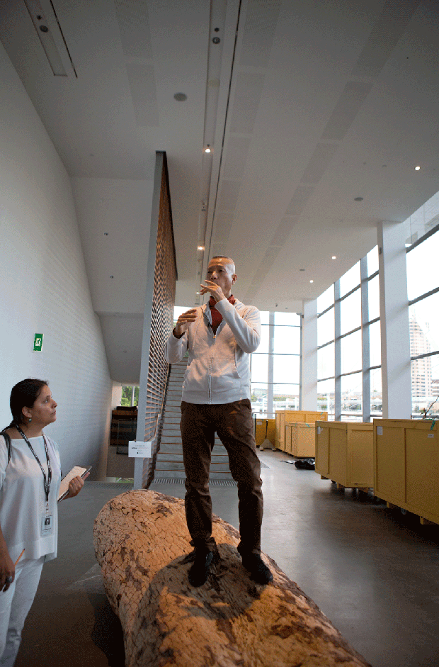 Cai Guo-Qiang pretending to play the flute during installation process, 2013. Photo courtesy Cai Studio. 